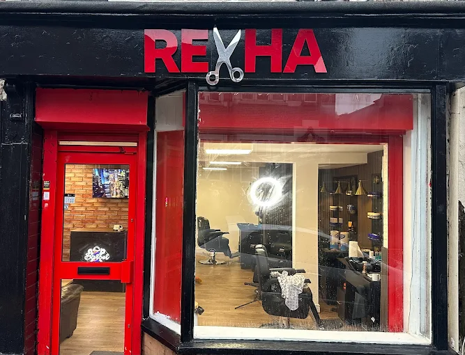 Rexha Barbers red and black shopfront on Dudley High Street